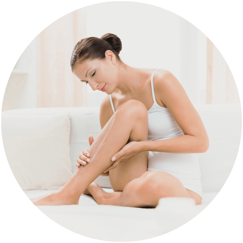 woman rubbing Nefertem lotion onto legs
