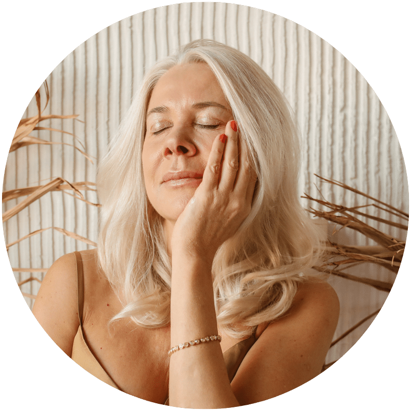 woman applying Nefertem moisturizer to face
