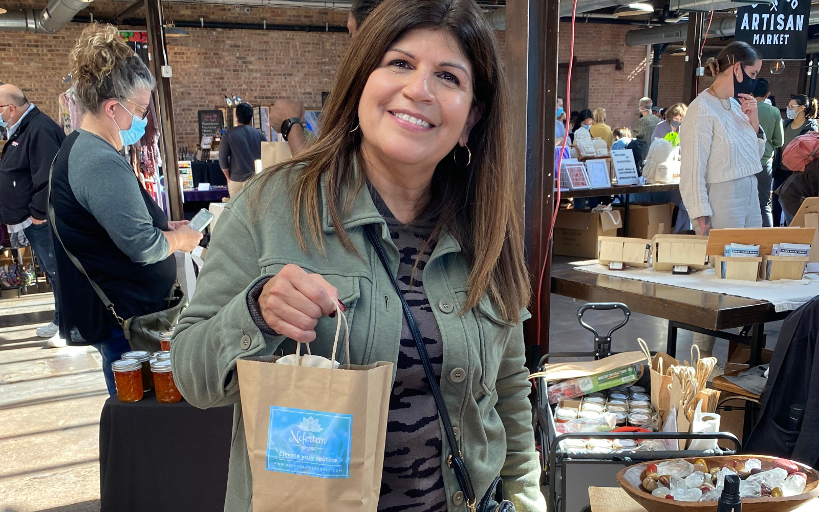 woman at event in Chicago holding bag of tallow skincare products