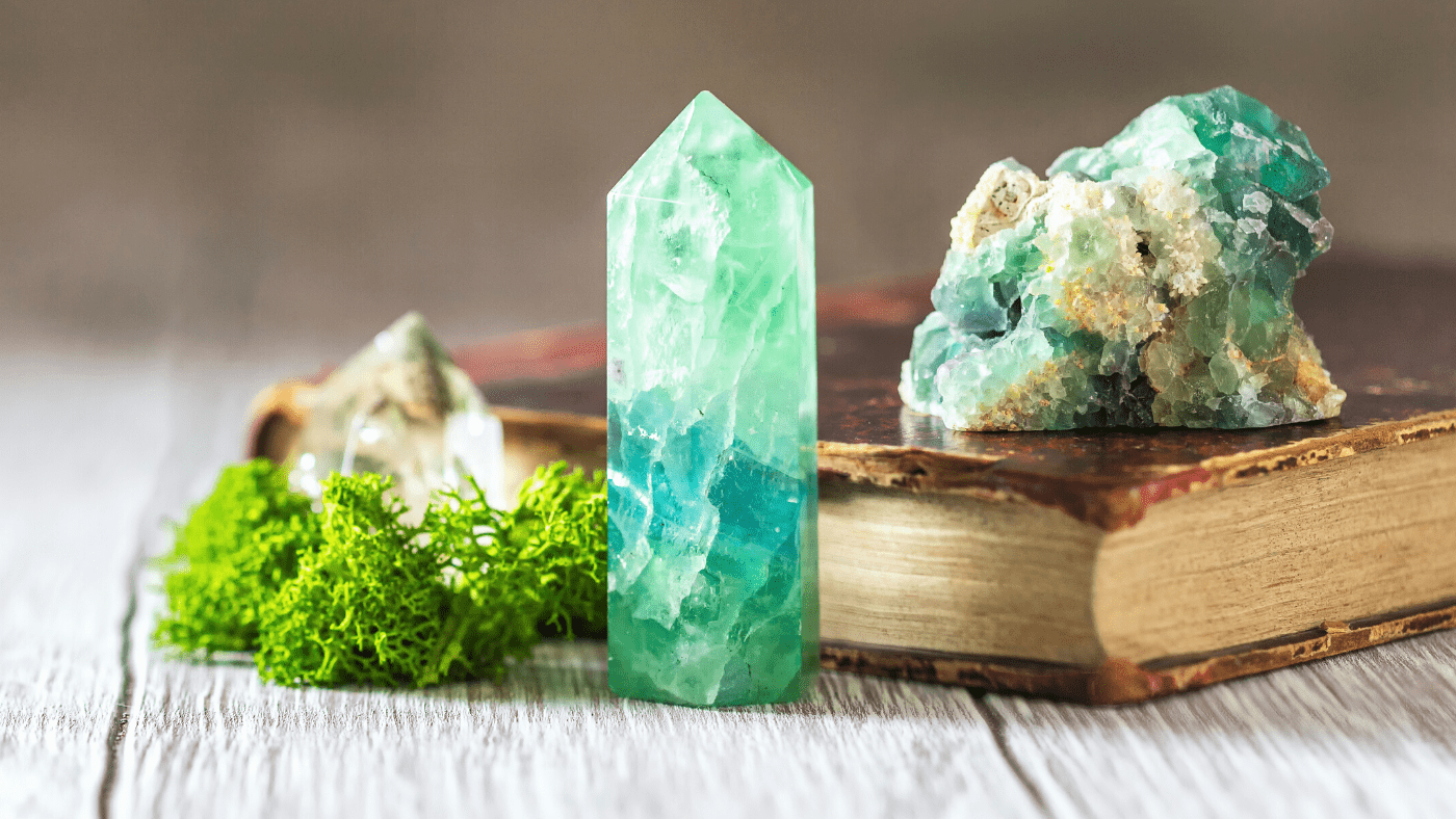 green crystals used for manifesting on tattered journal