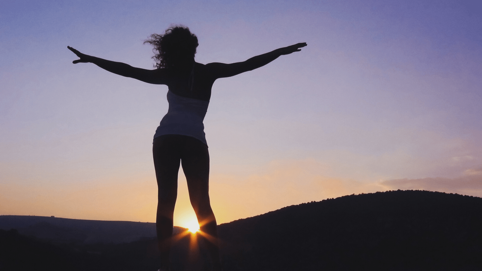 Woman looking at sunset in the back of nefertem soap studio 