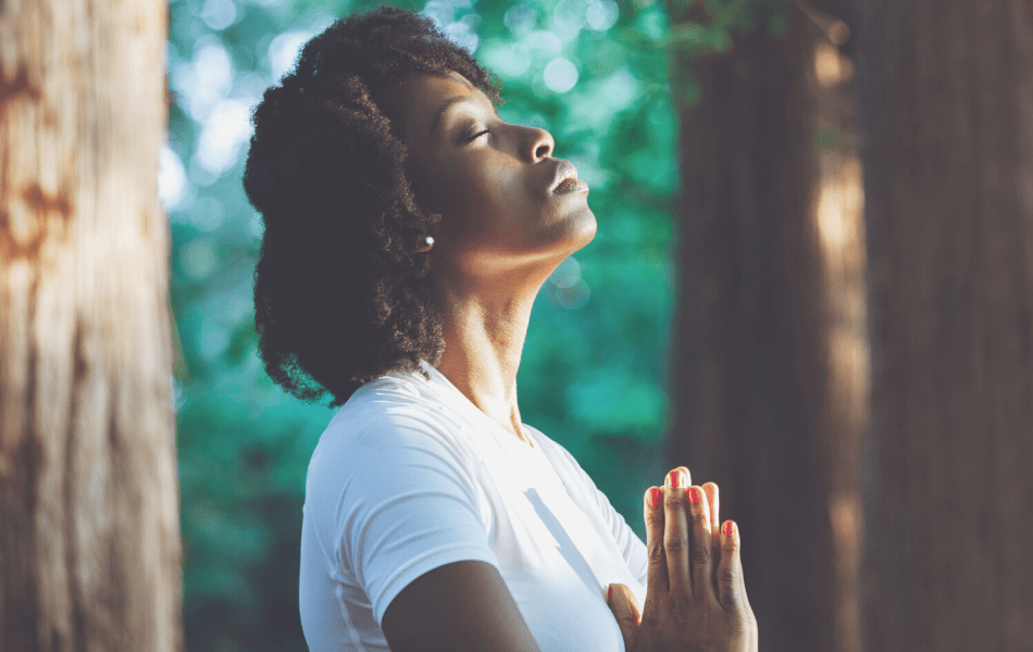 woman praying through meditation for healthier skin