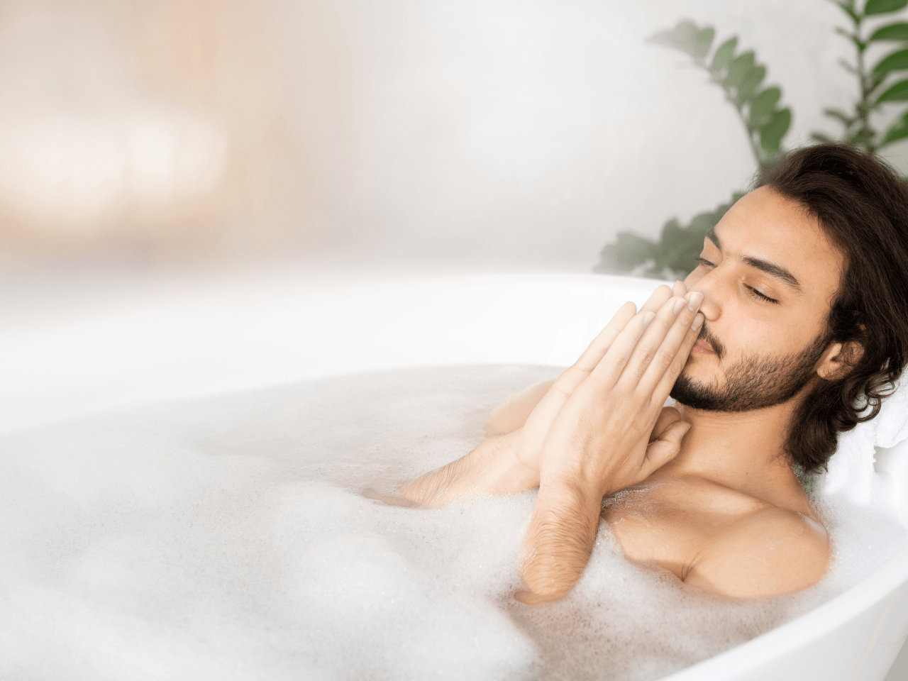man meditating in bath practicing conscious bathing