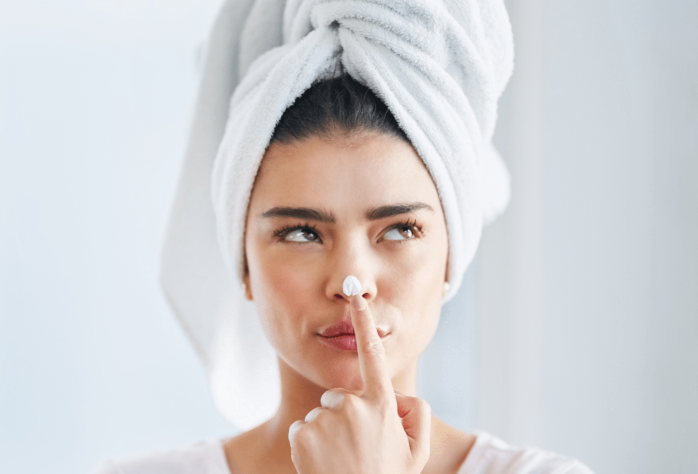 women thinking with lotion on nose