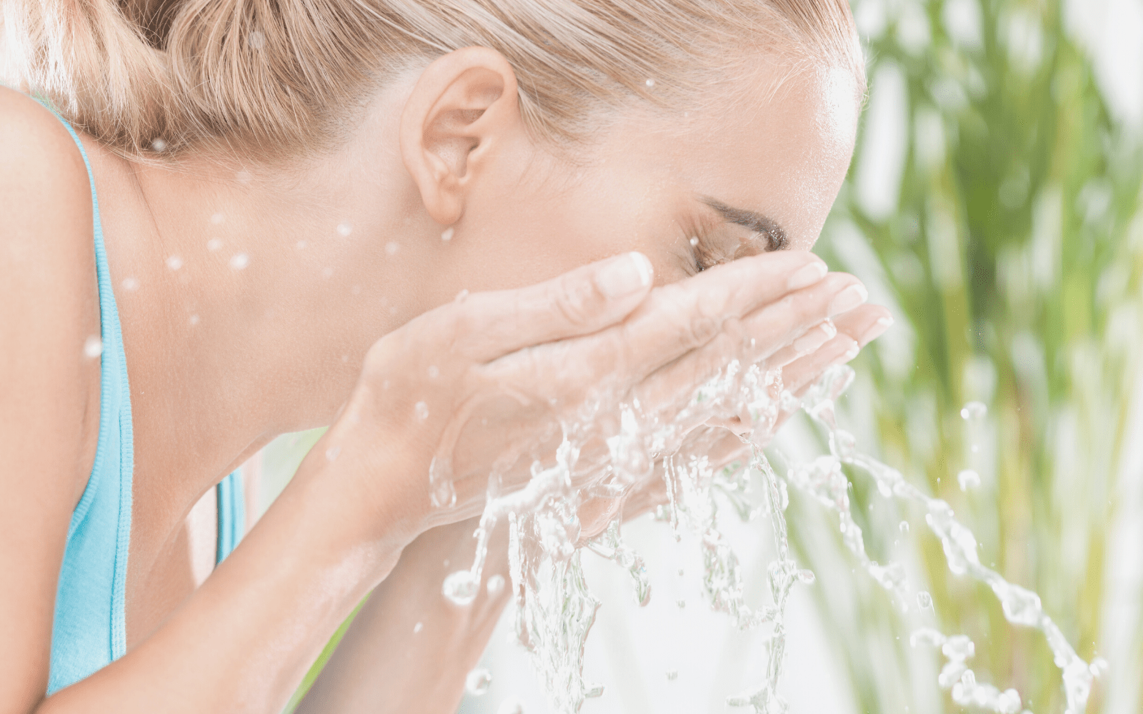 woman splashing face with water to hydrate skin naturally