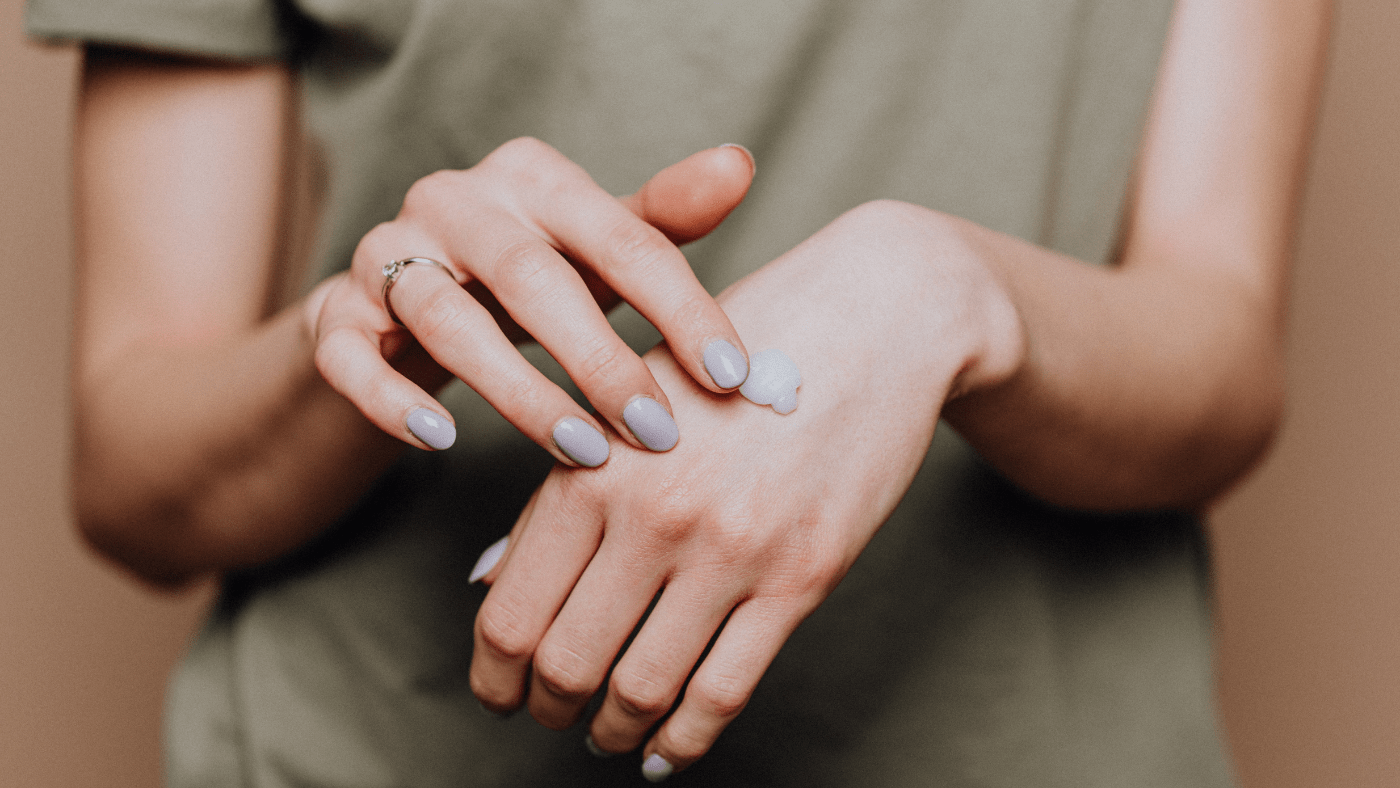woman getting ready to rub small amount of lotion into her skin