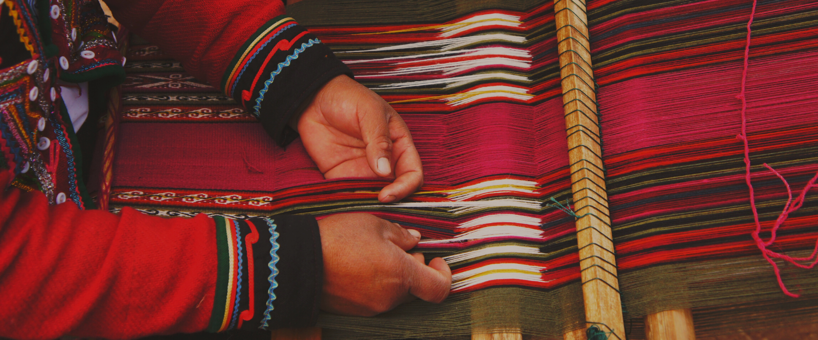 woman weaving thread on loom