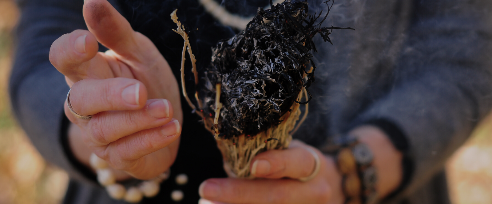 woman holding sage stick instead of sage spray