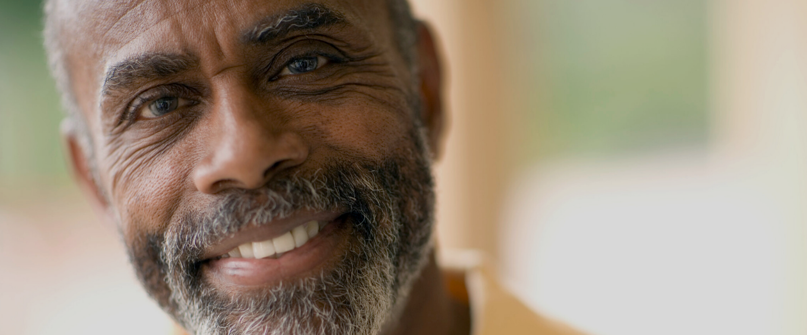 older man smiling after using natural skincare