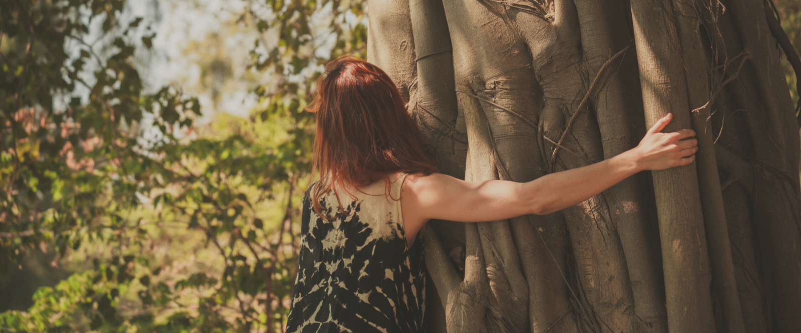 woman hugging tree after using nefertem holistic skin care