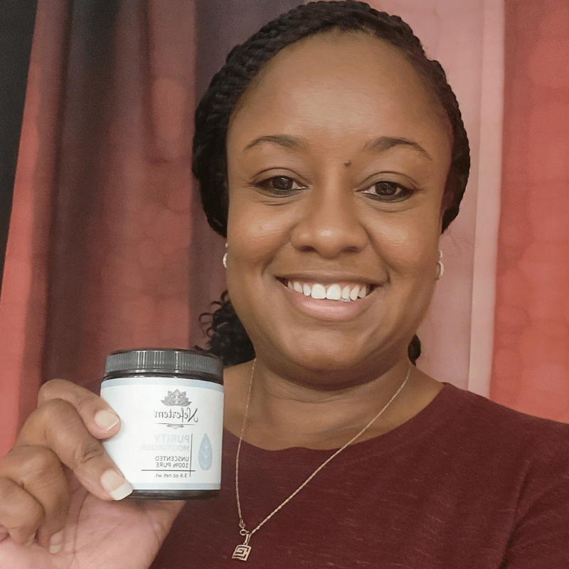 woman holding Purity Natural Moisturizer unscented