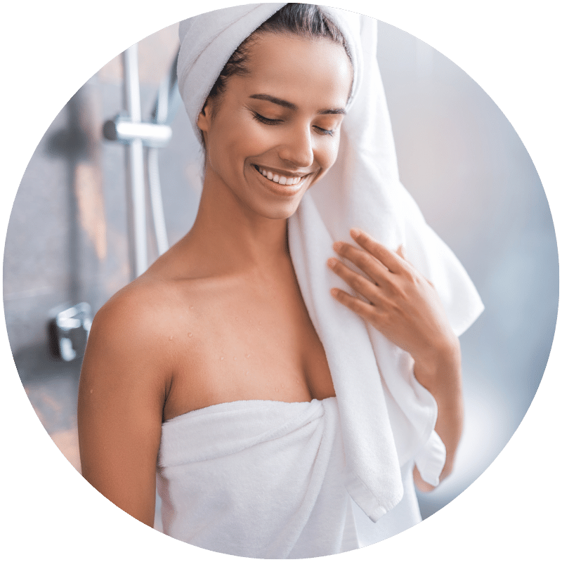 happy woman getting out of the shower after using Nefertem aromatherapy soaps