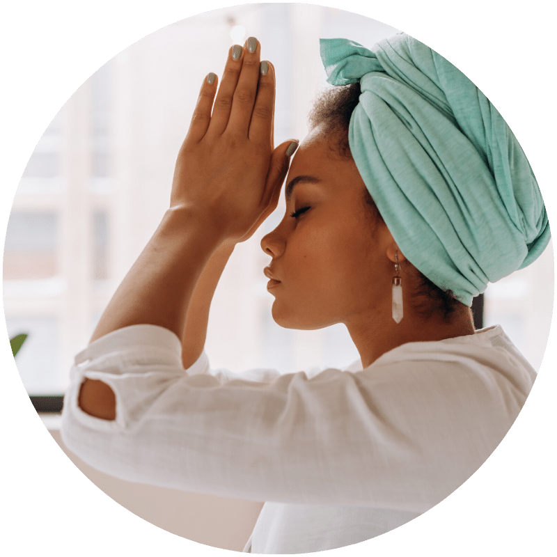 woman praying and meditating before mindful showering with natural skincare