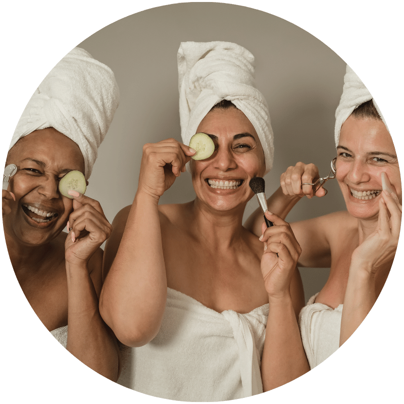 three women using Nefertem skincare products from gift set