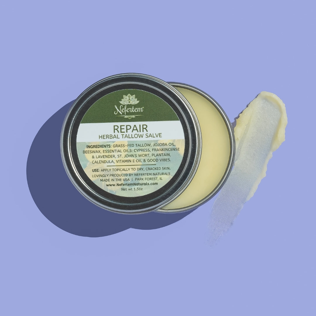 Nefertem Repair Herbal Tallow Salve with open lid on a purple background