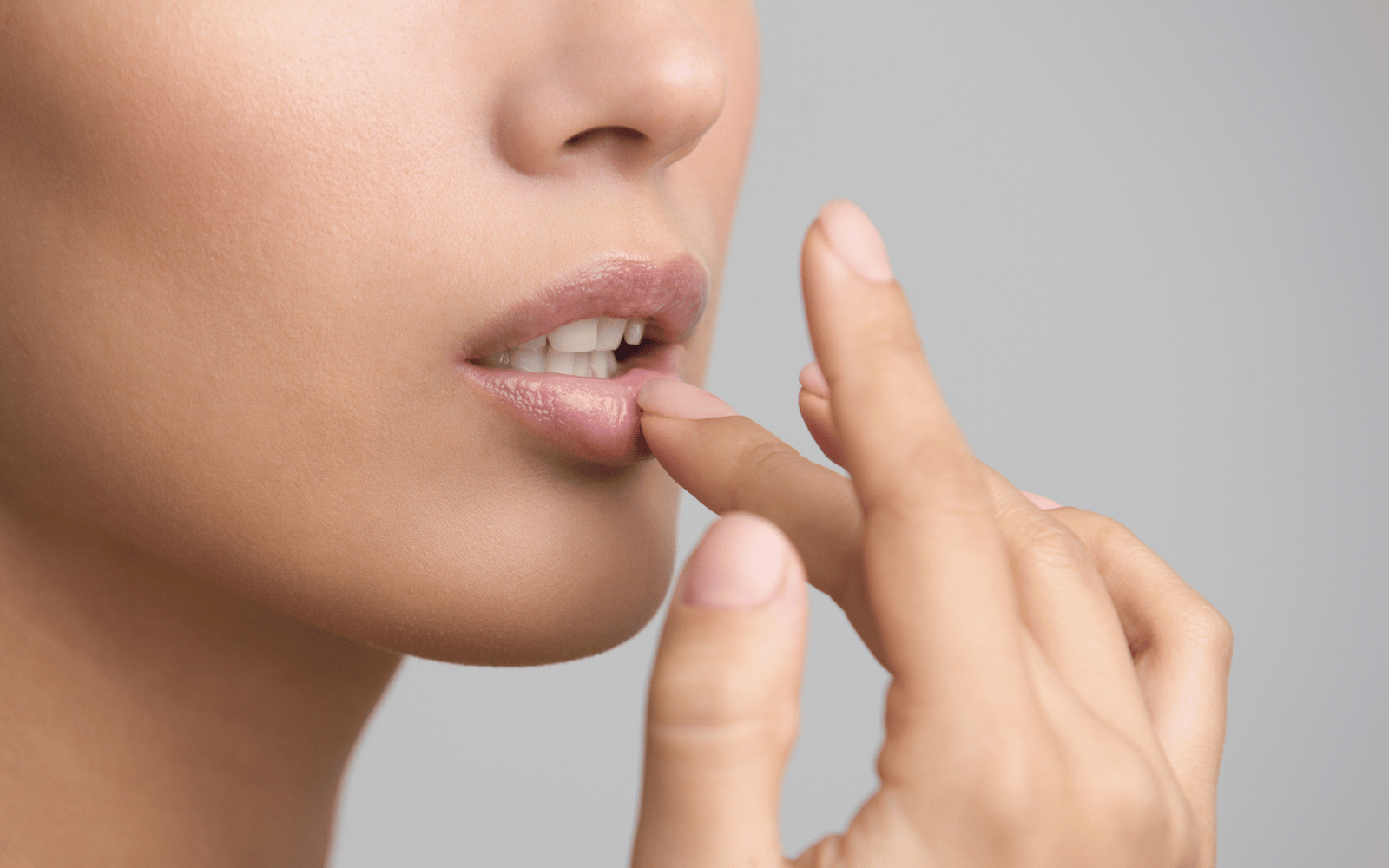 woman applying natural lip balm
