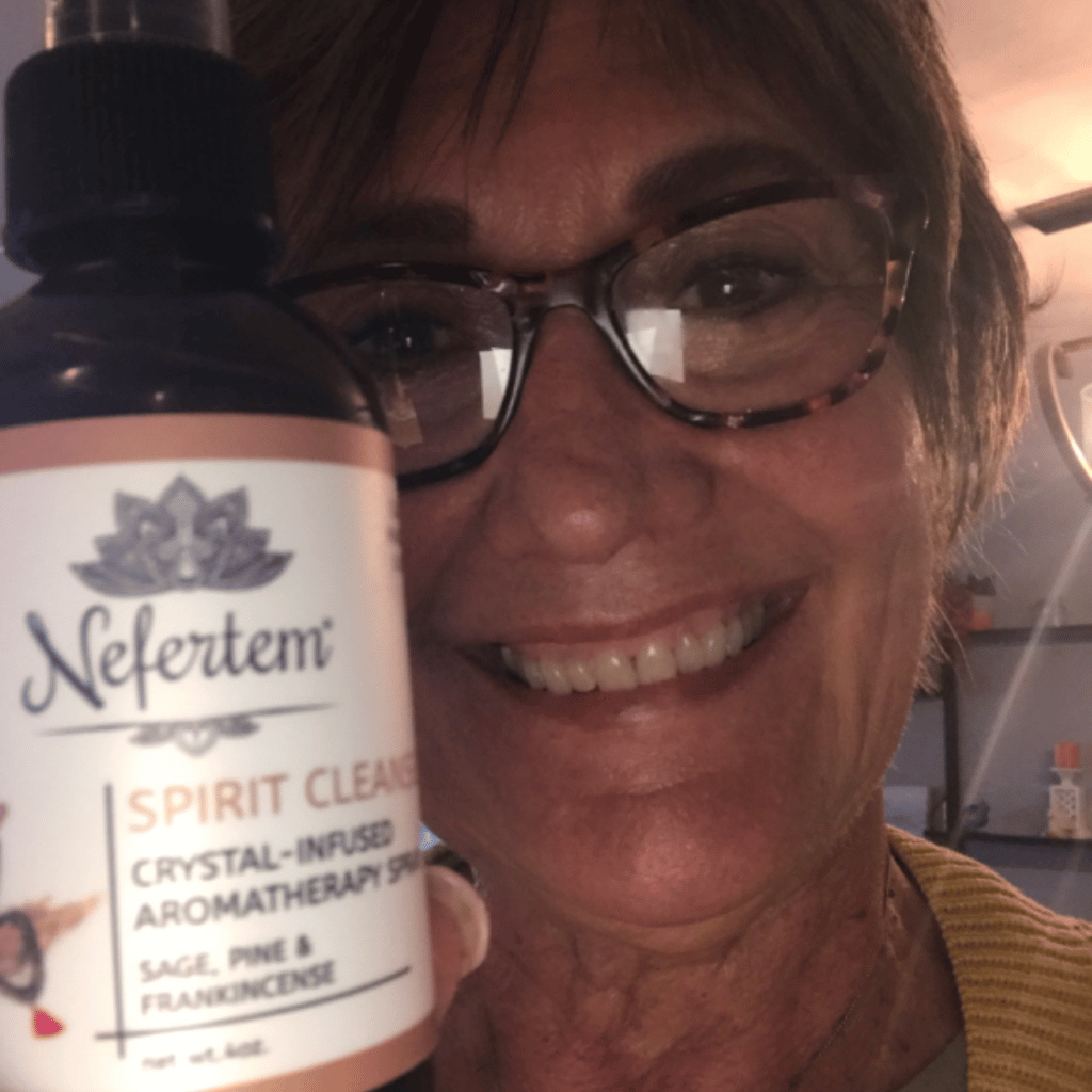 woman holding Nefertem's natural smudge sage spray