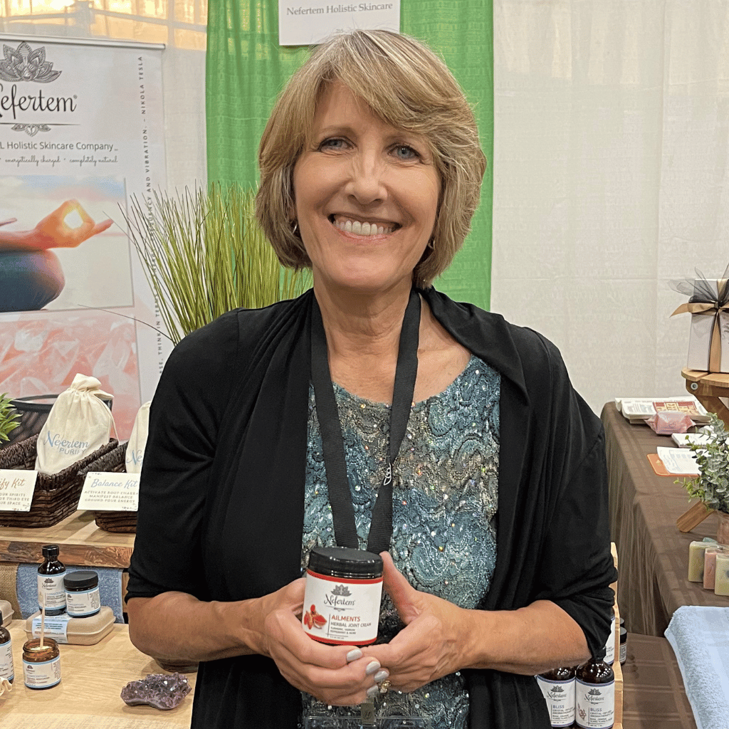 woman holding jar of Ailments herbal joint cream