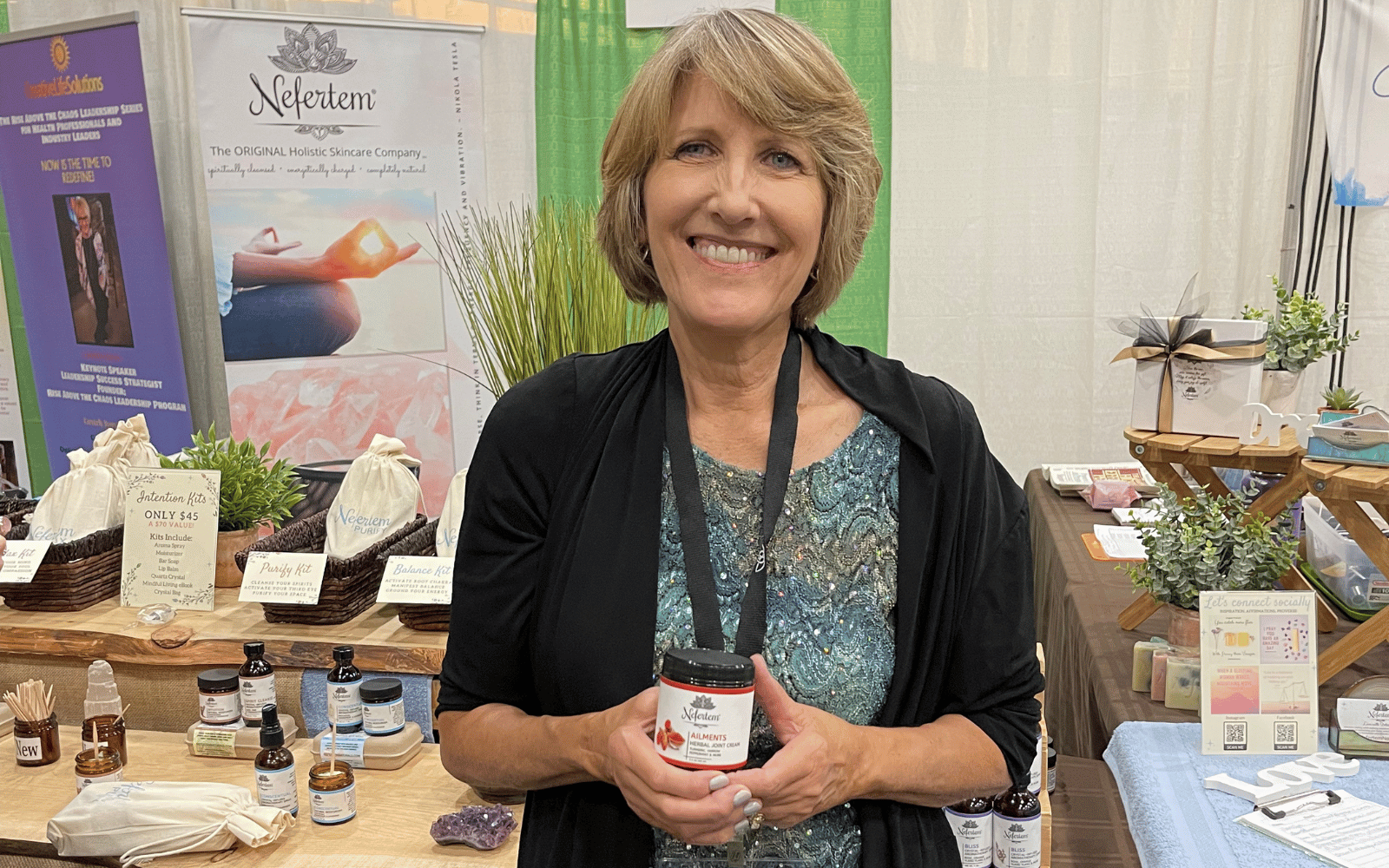woman holding jar of Ailments Herbal Cream