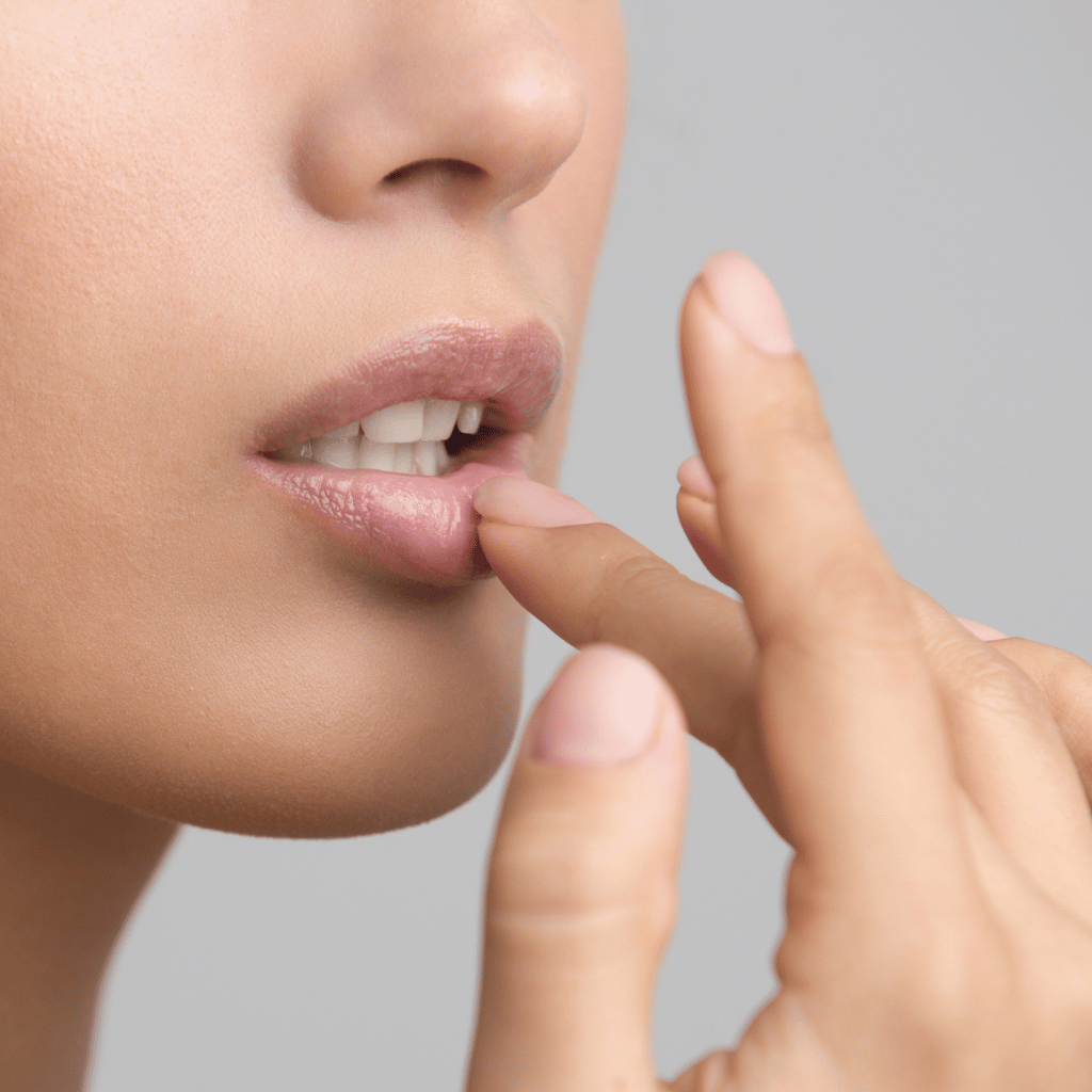 woman applying natural lip balm to lips