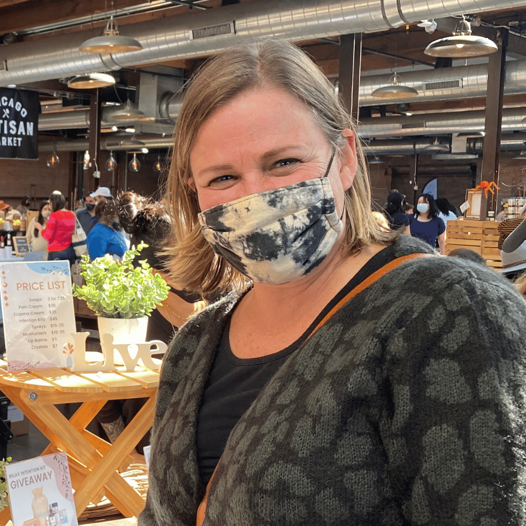 woman at expo happy about natural soap purchase