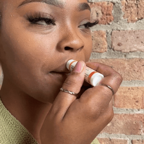 applying lip balm to lips