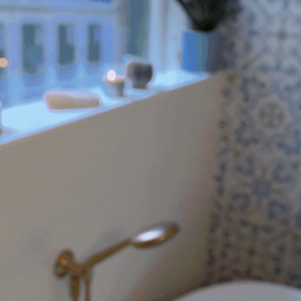 woman using Nefertem bar soap in bathtub