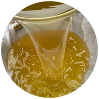 liquid tallow being poured through strainer