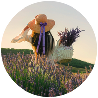 woman holding basket of lavender outside